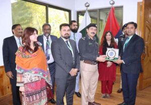 Commissioner Abbottabad, Zaheer ul Islam presenting a shield to Ms Seemi A Khan, DS NIMS Islamabad