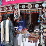 People purchasing traditional items from stalls setup during Ten-Days 'Folk Festival Lok Mela' at Lok Virsa