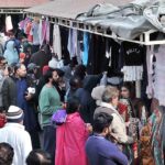 A large number of people busy in selecting and purchasing second hand warm clothes at weekly Sunday Bazaar, Aabpara