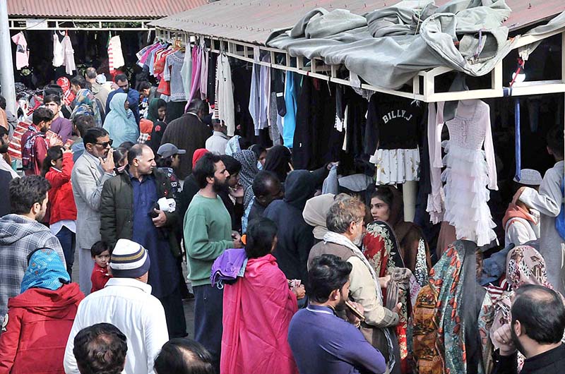 A large number of people busy in selecting and purchasing second hand warm clothes at weekly Sunday Bazaar, Aabpara