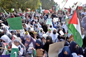 Students carrying Palestinian flags, banners and placards as they hold pro-Palestinian demonstration to show solidarity with Palestinians outside Faisal Mosque. 