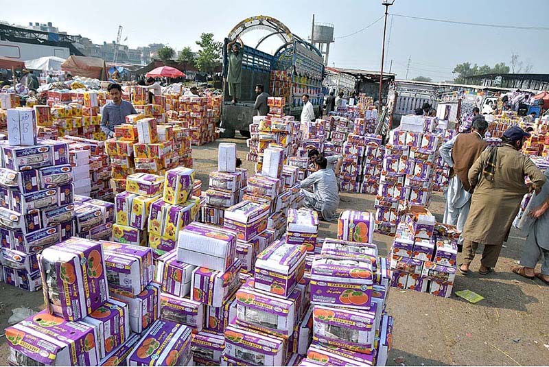 Vendors waiting for customers to sell fruit boxes at Fruit and Vegetable Market