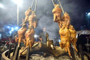 A vendor busy in preparing traditional food item “sajji” to attract the customers at KhanaPul. 