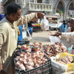 A person buying claymade lamps from vendor during Dewali festival