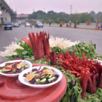 A vendor displaying salad to attract customers at Moti Mahal.