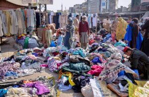 People busy in selecting second hand clothes from a vendor at Raja Bazaar