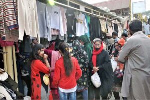 A large number of people busy in selecting and purchasing second hand warm clothes at weekly Sunday Bazaar, Aabpara