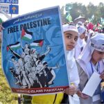 Students carrying Palestinian flags, banners and placards as they hold pro-Palestinian demonstration to show solidarity with Palestinians outside Faisal Mosque.