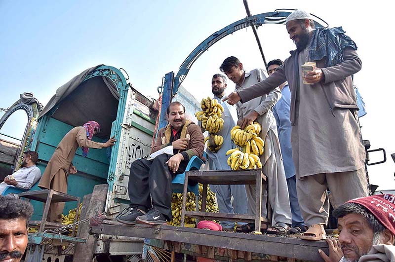 Vendors waiting for customers to sell fruit boxes at Fruit and Vegetable Market