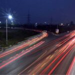 An attractive view of lights reflection on Islamabad Expressway during night time.