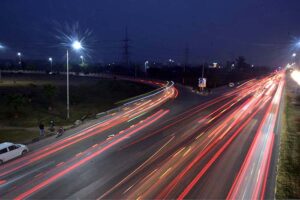 An attractive view of lights reflection on Islamabad Expressway during night time.