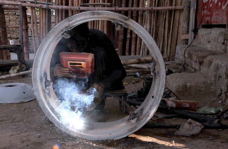 a welder busy in welding at his workshop