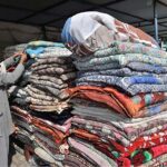 Worker busy arranging quilts at his shop for upcoming winter season at their workplace as the demand of warm goods increased after the temperature dropping rapidly in the city