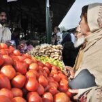People purchasing vegetables from vendor at weekly Sunday Bazaar, Aabpara