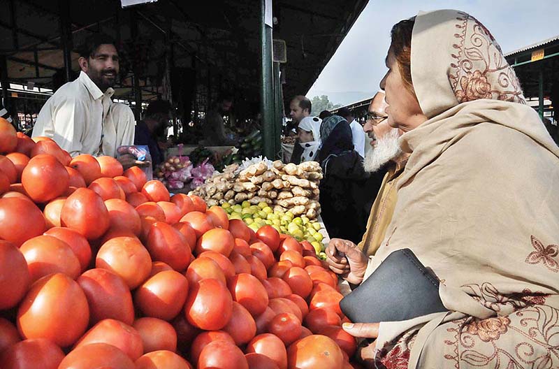 People purchasing vegetables from vendor at weekly Sunday Bazaar, Aabpara