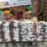 Shopkeeper displaying and selling sweet items at his shop