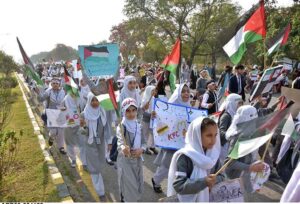 Students carrying Palestinian flags, banners and placards as they hold pro-Palestinian demonstration to show solidarity with Palestinians outside Faisal Mosque.