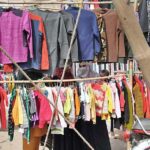Women busy in selecting and purchasing second hand warm clothes from vendor at Shakriyal