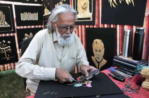 People purchasing traditional items from stalls setup during Ten-Days 'Folk Festival Lok Mela' at Lok Virsa