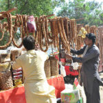 A vendor showcasing figs (anjeer) on his handcart to attract customers at Tower Market.