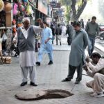 Sanitary workers busy in cleaning manhole at Aabpara in Federal Capital.