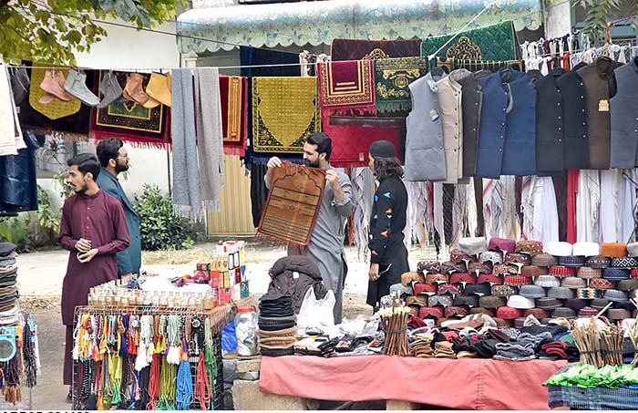 A vendor displaying and selling Prayer mats and caps at his roadside setup near G-6 in the Federal Capital.