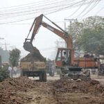 Heavy machinery being used during road construction work at Millat Road