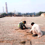 Labourer busy in renovation and reconstruction work of Royal Fort during maintenance and development work in the city