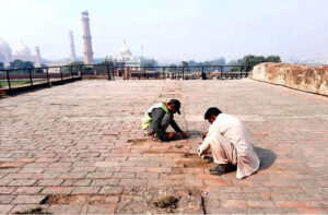 Labourer busy in renovation and reconstruction work of Royal Fort during maintenance and development work in the city