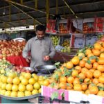 A vendor selling fruits at weekly Sunday bazar Aabpara in the Federal Capital