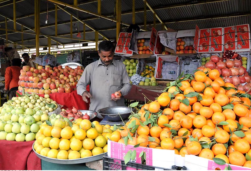 A vendor selling fruits at weekly Sunday bazar Aabpara in the Federal Capital