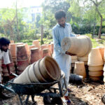 PHA workers preparing plant pots at Local Park