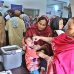 Lady Health Worker administering polio drops to a child during anti-polio campaign at Bhitai hospital.
