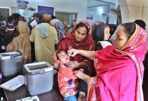 Lady Health Worker administering polio drops to a child during anti-polio campaign at Bhitai hospital. 