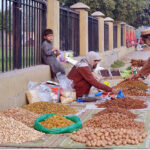 A vendor displaying and selling dry fruit on the roadside to attract customers