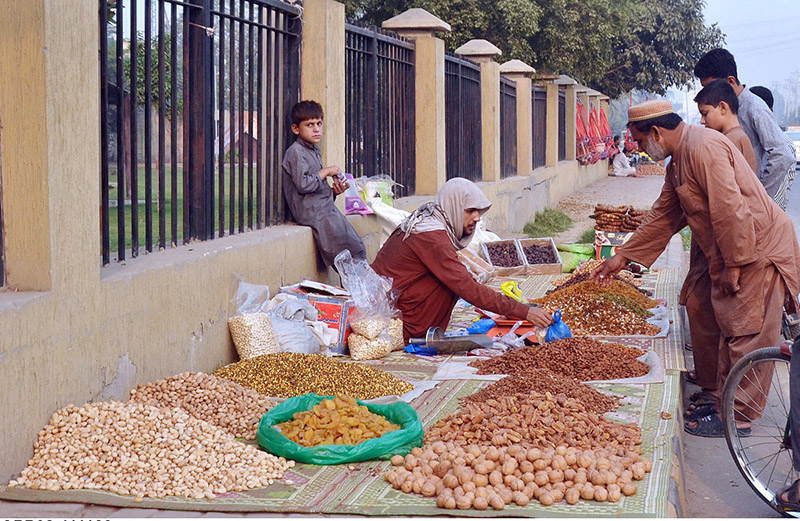 A vendor displaying and selling dry fruit on the roadside to attract customers