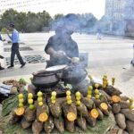 A vendor displaying roasted sweet potatoes to attract the customers.