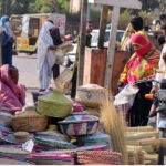 Elder woman vendor displaying and selling handmade and other household items to earn a livelihood