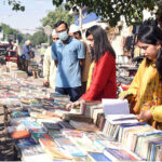 People busy in selecting and purchasing old books from roadside setup in Provincial Capital