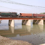 A beautiful view of goods train crossing the Phuleli Canal on Railway Bridge