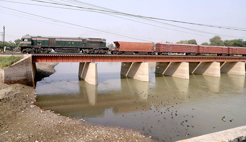 A beautiful view of goods train crossing the Phuleli Canal on Railway Bridge