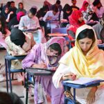 Students are solving their question papers during pre-entry test for admission at the Government Collage University