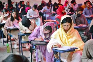 Students are solving their question papers during pre-entry test for admission at the Government Collage University