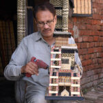 Worker busy in giving final touch on the decoration piece at his work place