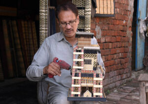 Worker busy in giving final touch on the decoration piece at his work place
