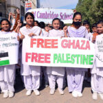 Students of Royal Cambridge school Holding placards during rally in support of Palestinians at Latifabad.