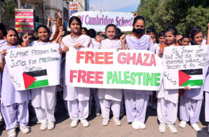 Students of Royal Cambridge school Holding placards during rally in support of Palestinians at Latifabad.