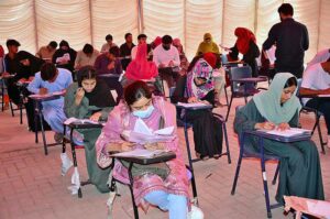 Students are solving their question papers during pre-entry test for admission at the Government Collage University