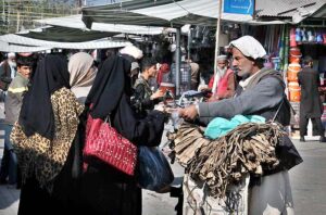 Women purchasing ‘Dandasa’ (peel of walnut tree) to be used for natural teeth whitening at Weekly Bazaar in Federal Capital. 