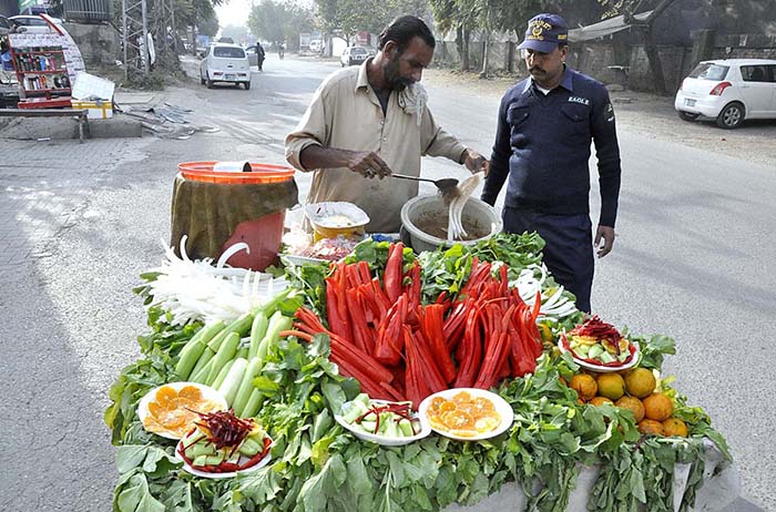 A vendor displaying carrots and radish to attract the customers.
